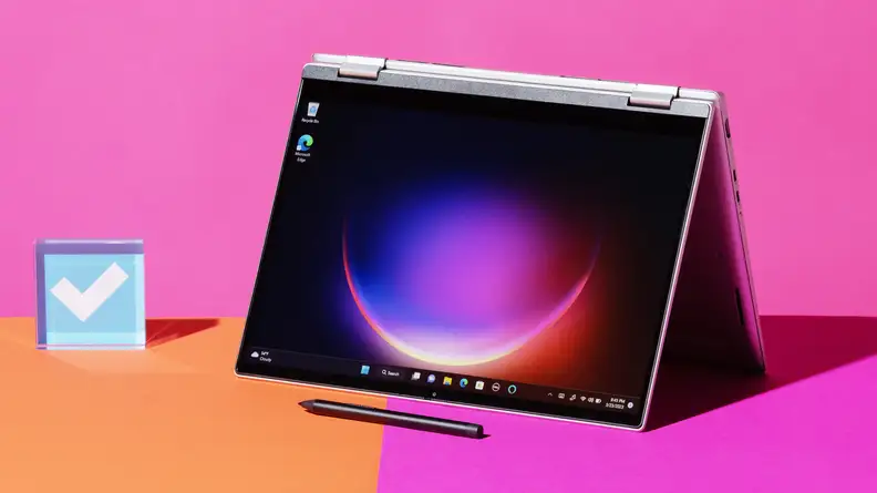 The Dell Inspiron 14 7420 in its tablet form with a stylus in front of it and the Reviewed logo next to it.