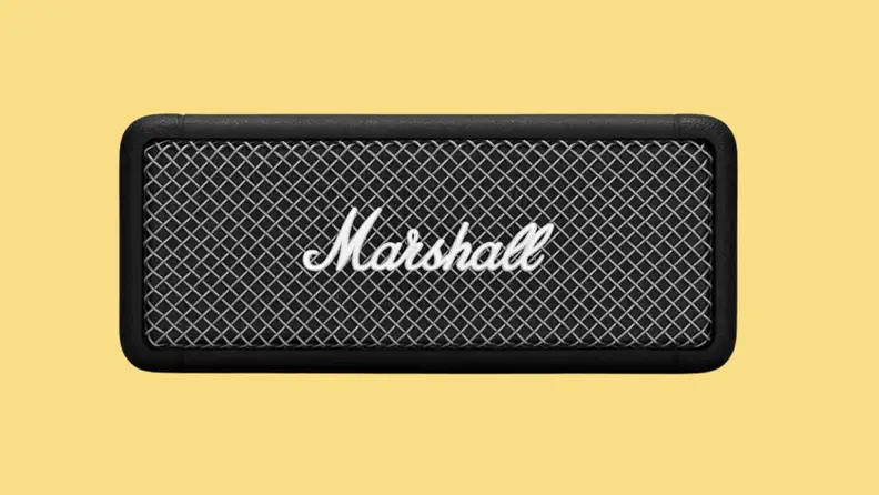 A Marshall Emberton speaker against a light gold background.