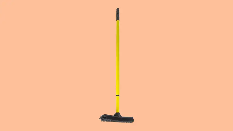 Furemover rake against a peach background