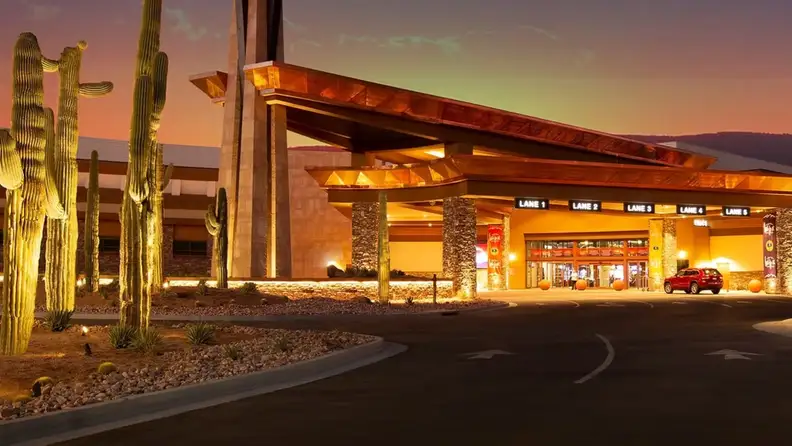 Road leading to the entrance to a casino resort in the Phoenix desert during sunset