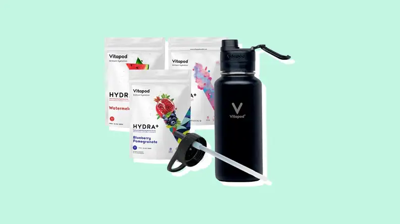 Three Vitapod drink packets next to black insulated water bottle.