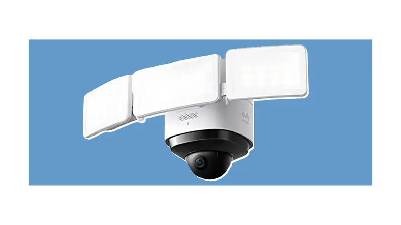 A wired security camera in front of a background.