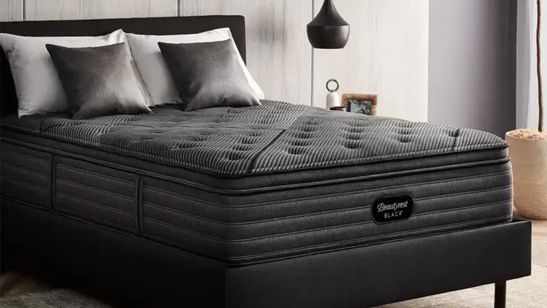 Beautyrest Black mattress to the side in a bedroom setup.