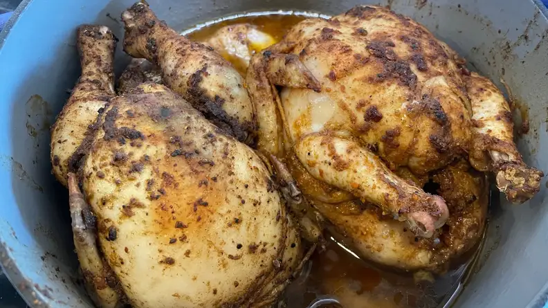 Two, whole roasted chickens inside of the Great Jones Dutch Baby oven.