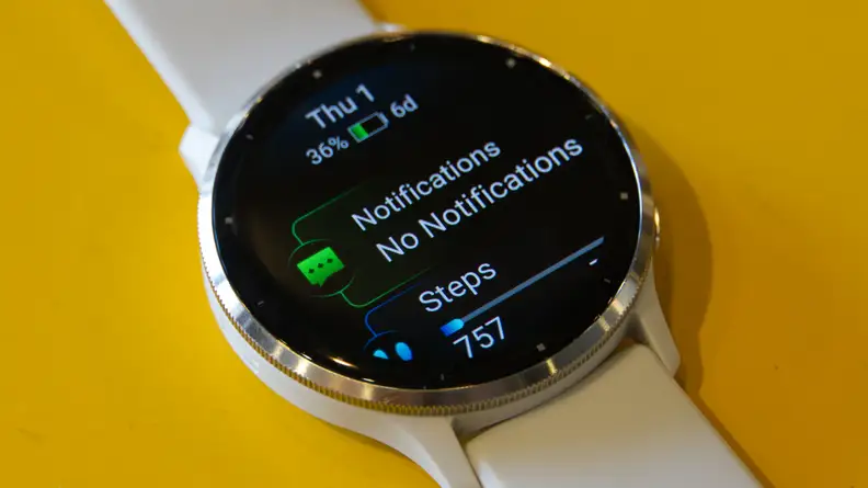 Garmin Venu 3 smartwatch with notifications and step tracker on watch face screen.