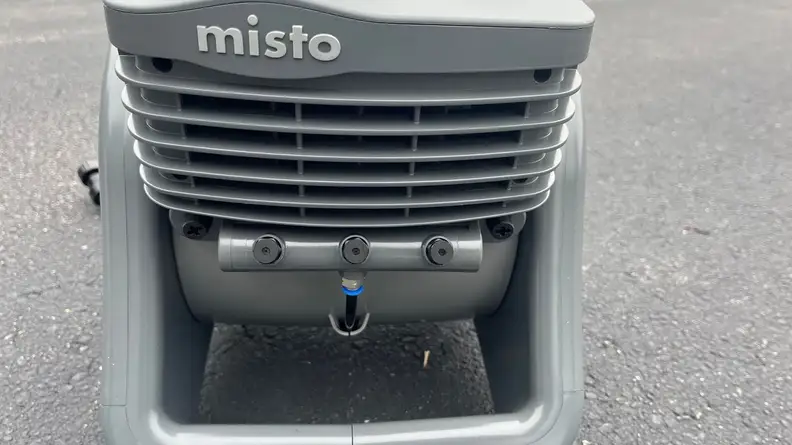 Front view of the Lasko Misto showing the name, fan vents, and mister nozzles.