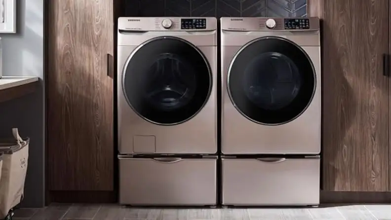 A laundry room with a rose gold washer and dryer side by side.