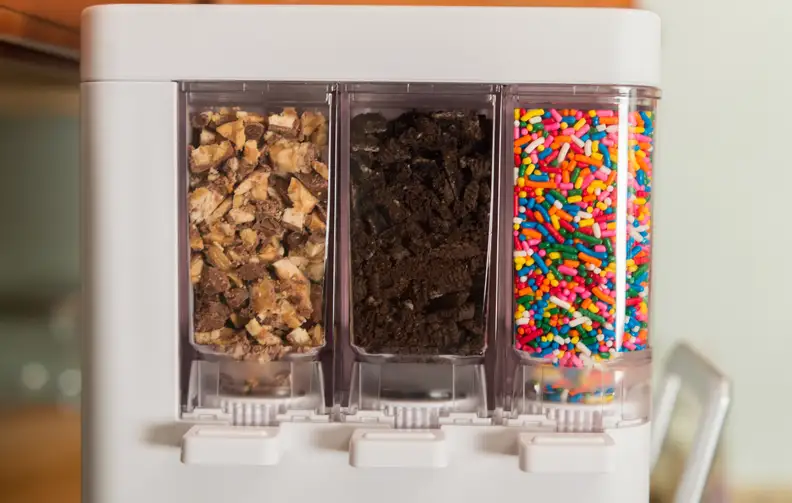 Here's where the magic happens. We've got rainbow sprinkles, Oreo cookies, and chopped Snickers.