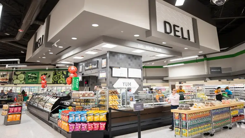 Publix deli counter with subs, wraps, and salads signage