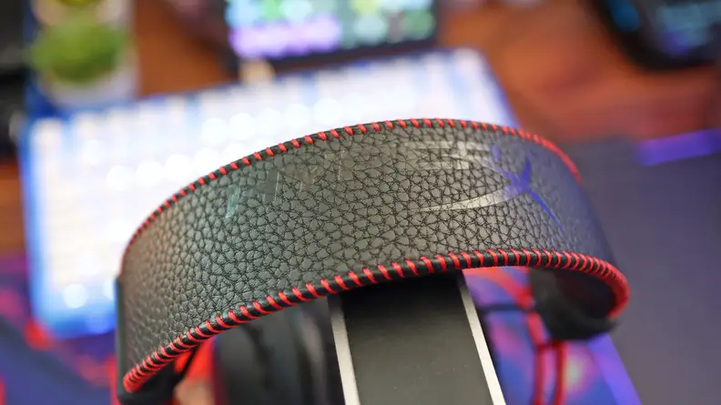 A close up of a black and red gaming headset headband