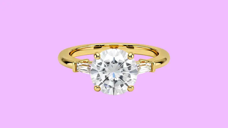 Brilliant Moissanite Tapered Baguette Three Stone Lab Diamond Ring against a purple background.
