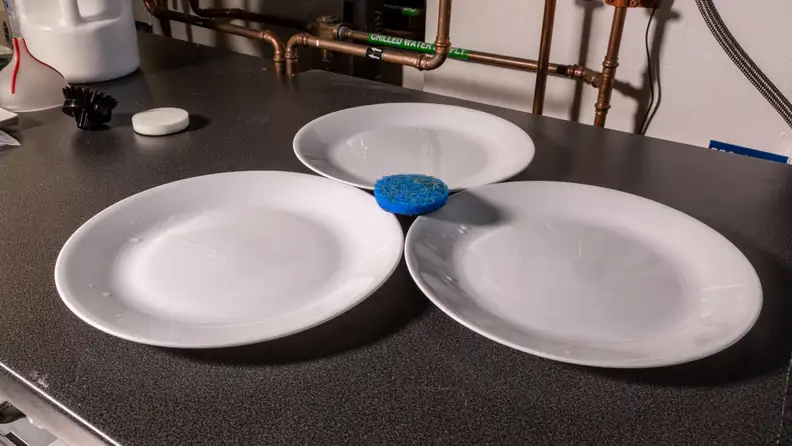 We got the plates scrubbed clean, but it flung debris everywhere.