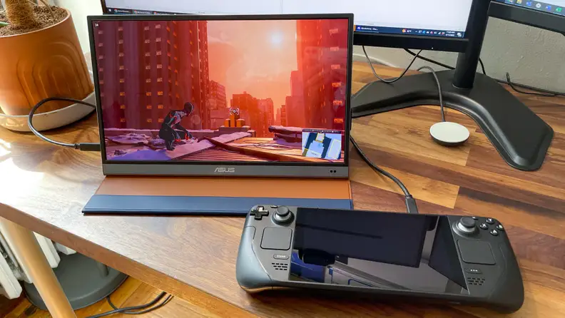 A laptop and Nintendo Switch next to each other on a desk.