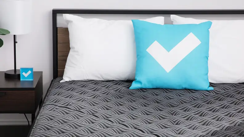The mattress with the Reviewed logo pillow.
