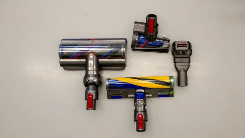 The attachments for the Dyson Gen5detect laid on out the floor including the Fluffy Optic, Digital Motarbar, Hair Screw, and Combination tool.