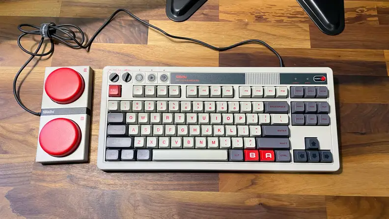 A grey retro keyboard with two large red buttons, the best budget gaming keyboard on the market