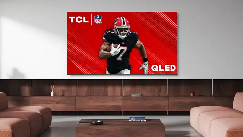 The TCL Q6 LED TV displaying a professional football player in a modern living room