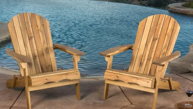 2 brown Adirondack chairs overlooking the water