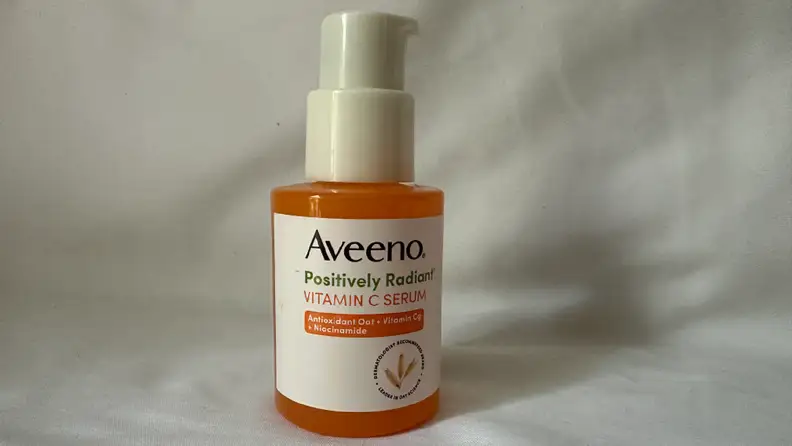Aveeno Vitmain C Serum against a grey background.