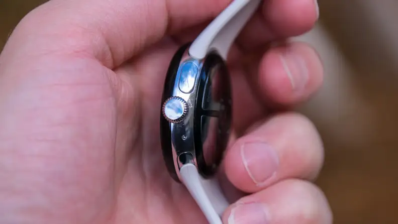 Our reviewer holds the Pixel Watch 2 in his hand, showing off its crown