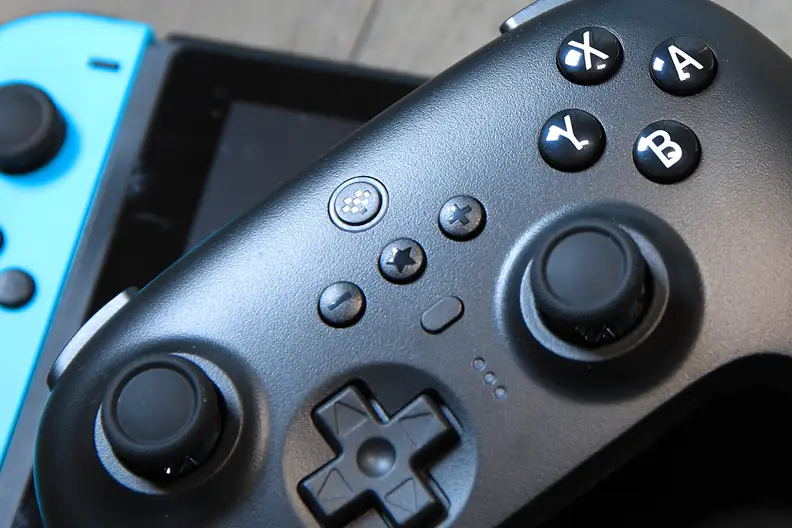 Looking at the front of a black plastic controller on a switch