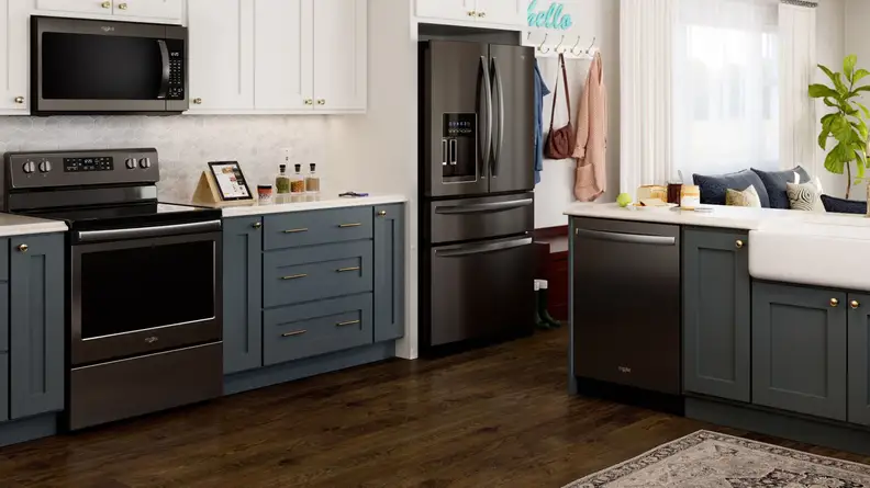 A kitchen with Whirlpool appliances in black stainless steel