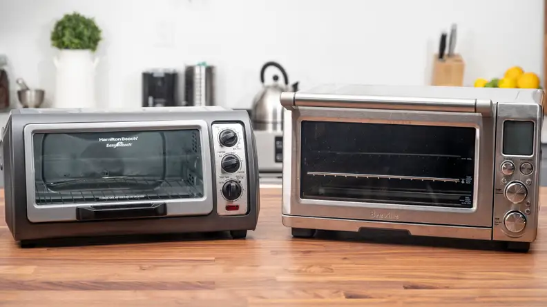 Toaster ovens sitting on a table.
