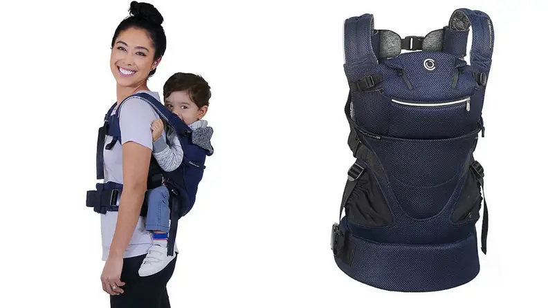 A parent carries their infant with a baby carrier.