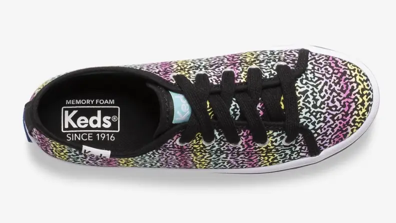 A colorful leopard print Keds shoe.