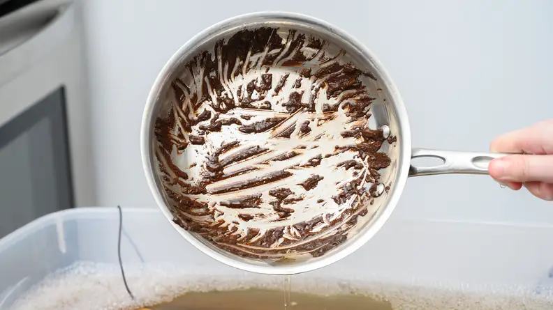 The stainless steel skillet with a burnt-on brownie stain.