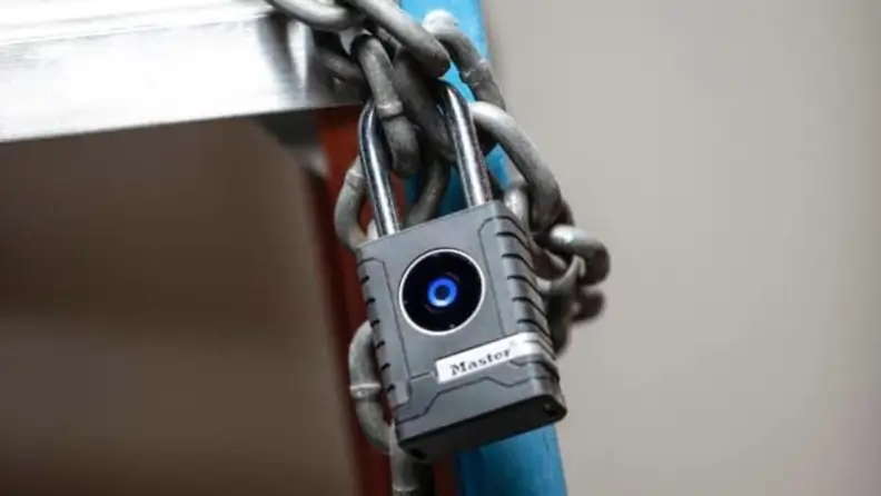 Master Lock Bluetooth Padlock affixed to a chain on a ladder