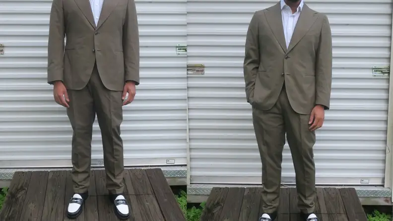 Man standing in front of storage shed wearing green cotton suit from Suitsupply.