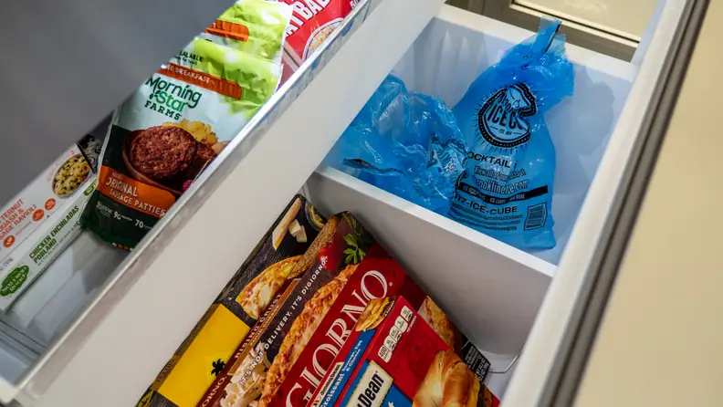 A few bags of ice in a pull-out drawer style freezer