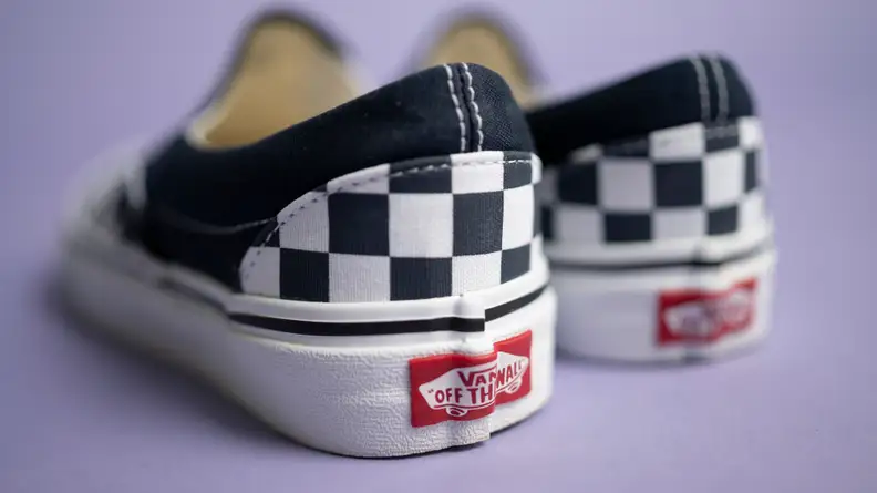 Close-up shot of the back of the Vans Checkered slip-ons, revealing the Vans logo.