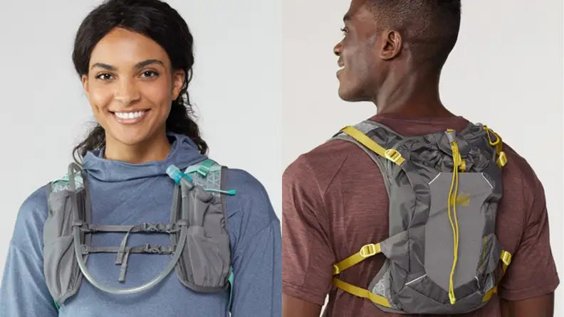 A man and a woman each wearing a hydration backpack