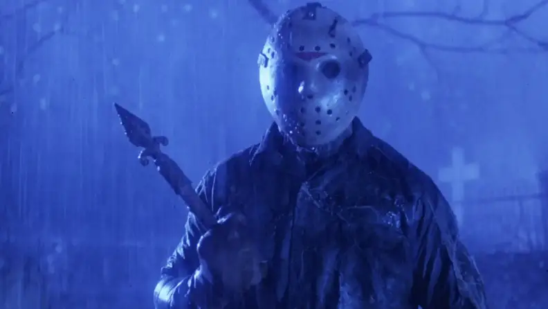 Jason Voorhees, the villain of the "Friday the 13th" series, in the rain, holding a spear.