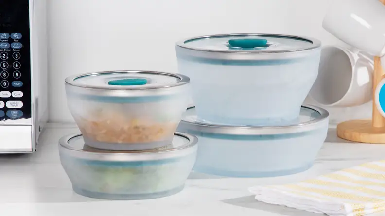 Anyday microwave cookware with lids stacked on top of each other on marble surface.