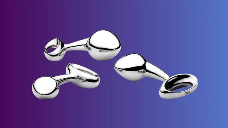 An anal sex toy sits on an indigo fade background