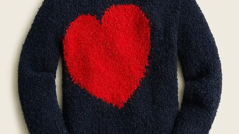Fuzzy navy children's sweater with red heart on front.