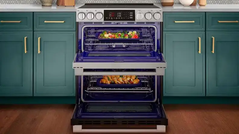 A family gathered in the kitchen near a double oven range