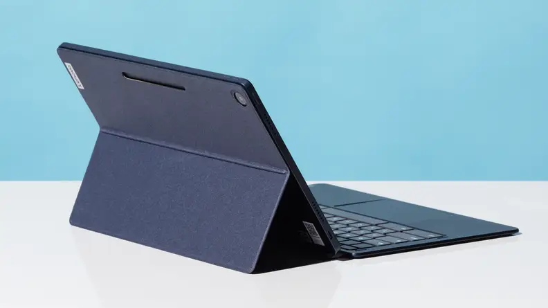 The Lenovo IdeaPad Duet 5 on a black kickstand, sitting on a white table.