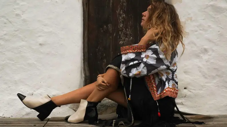 A woman wearing black and white booties.