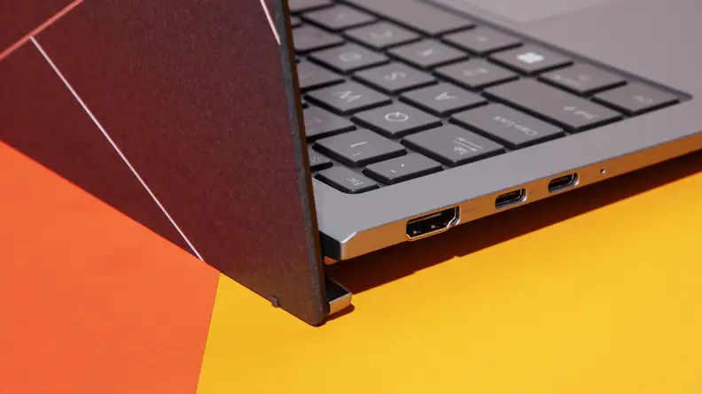 A close up of the side of a laptop that shows the lid open