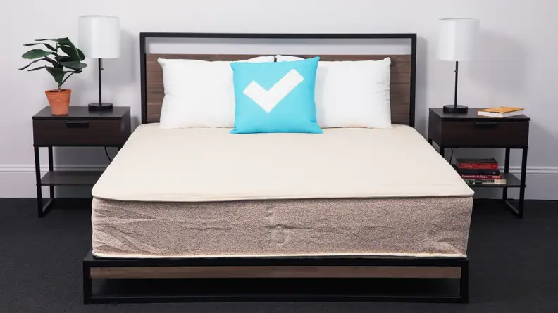A front view of the Birch Natural Mattress in a model room.