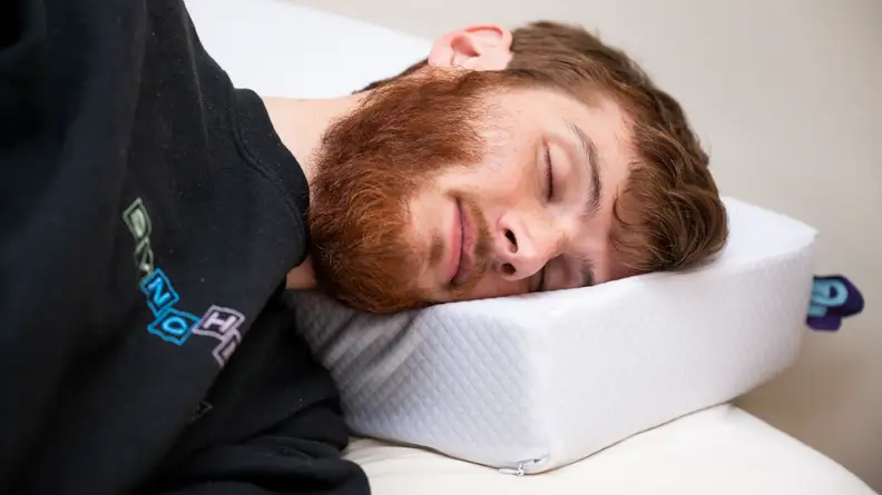 a person sleeps on the pillow cube
