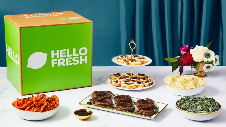 Beef tenderloin and sides on a table with a HelloFresh box.