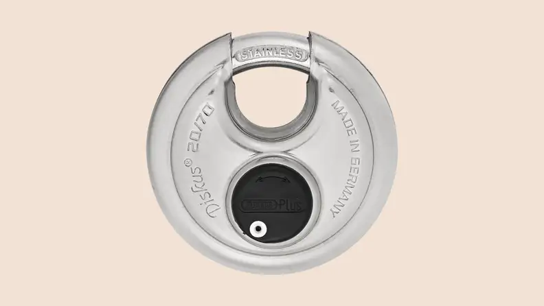 ABUS Diskus disk padlock against a plain beige background