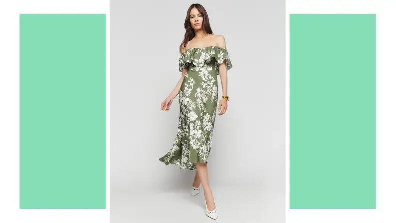 A model wears a green dress with a white floral print.