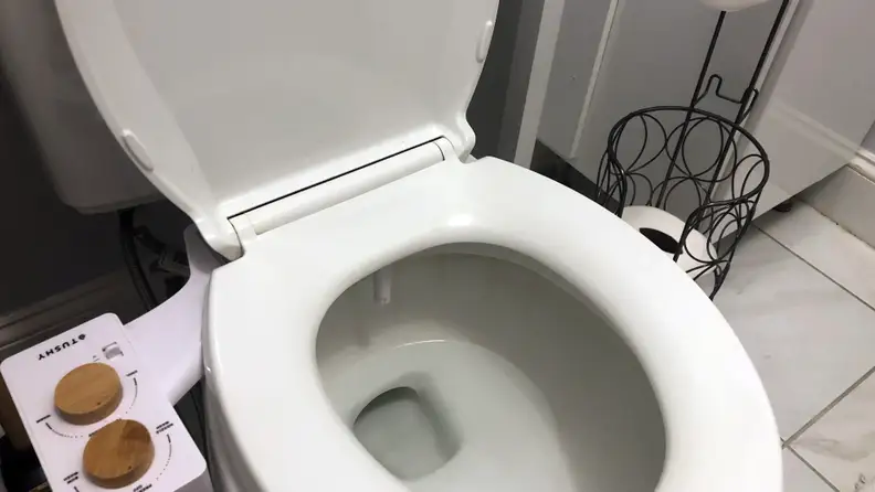 Tushy bidet on open toilet seat