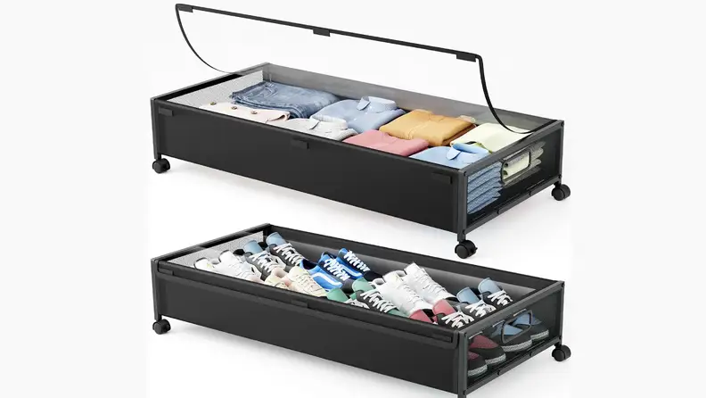Two black under-bed storage bins on wheels, one holding folded clothes and one holding shoes